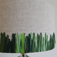 Close up of the hand embroidered green meadow lampshade