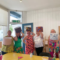 Four women holding colourful lampshades that they have made during my workshop at starling studio