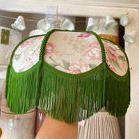 A green fringe lampshade with pink floral fabric panels, showing what you can make in the workshop