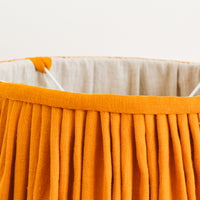 close up detail of mustard gathered french drum lampshade