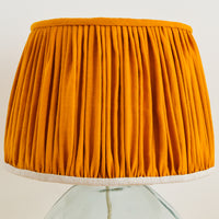 french drum mustard gathered lampshade on a glass lampbase