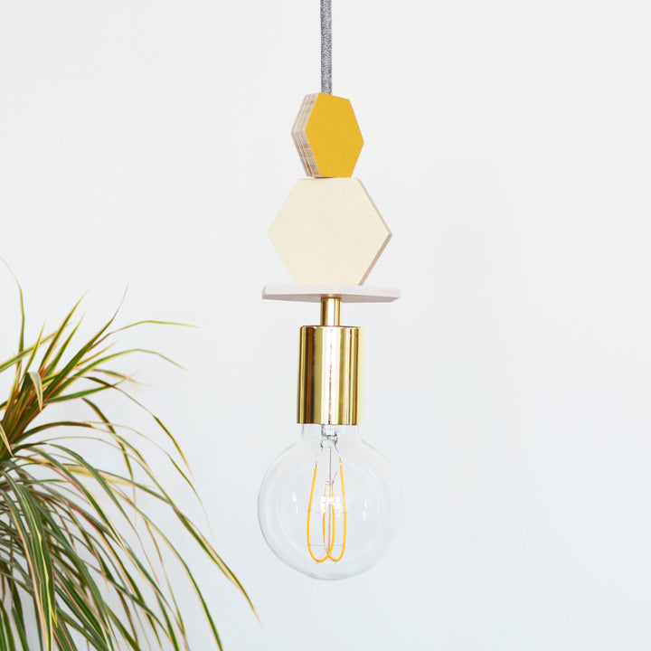 Hexagon plywood pendant light in mustard, pink and brass