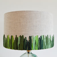 Hand embroidered linen lampshade featuring green meadow design