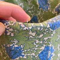 Student pinning a lampshade during a traditional lampshade making workshop starling studio