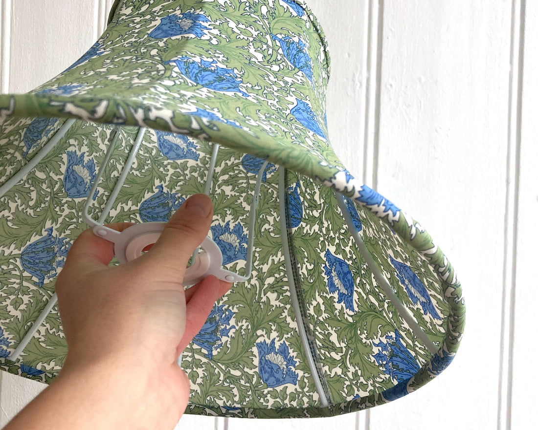student holding a finished bowed empire lampshade that they made in a lampshade making workshop at starling studio