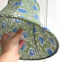 student holding a finished bowed empire lampshade that they made in a lampshade making workshop at starling studio