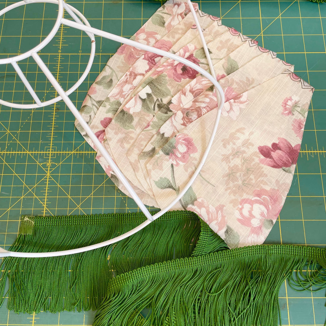 Vintage lampshade workshop materials, including frame, vintage fabric, tassel fringe and braid