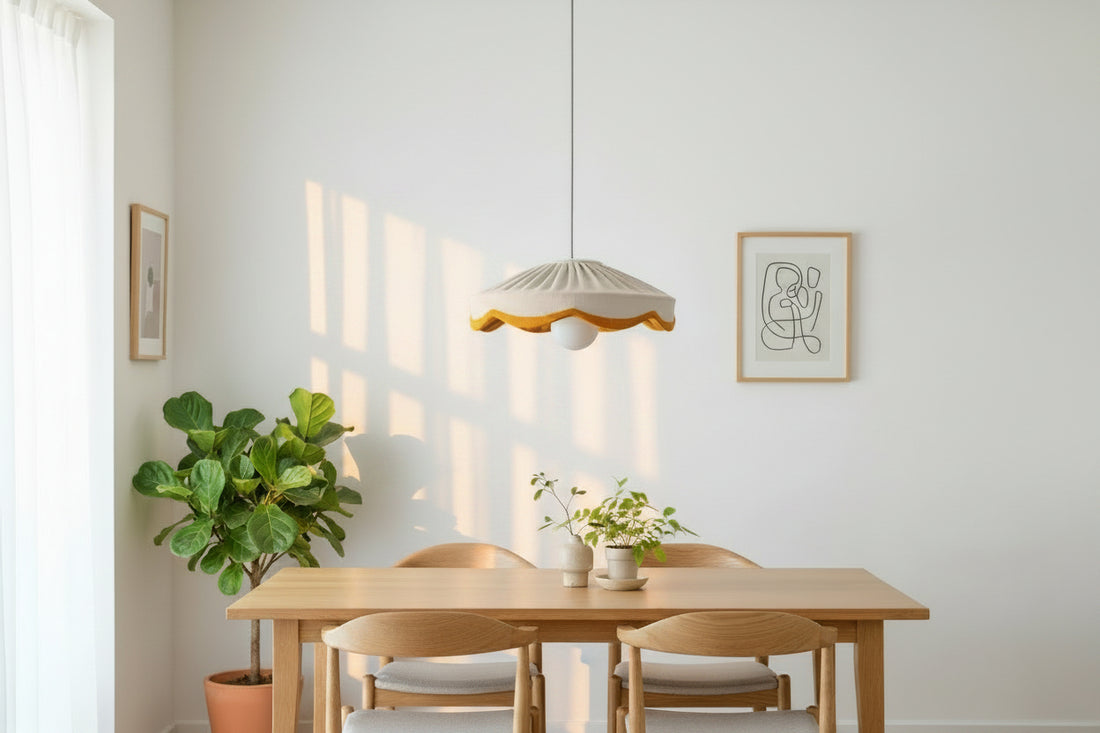 A natural linen pleated scallop lampshade with a mustard scalloped edge, hanging against a neutral background.