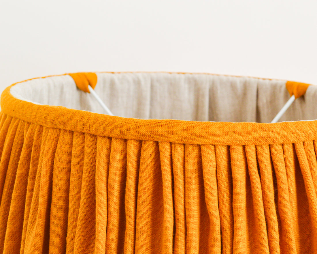 close up detail of mustard gathered french drum lampshade