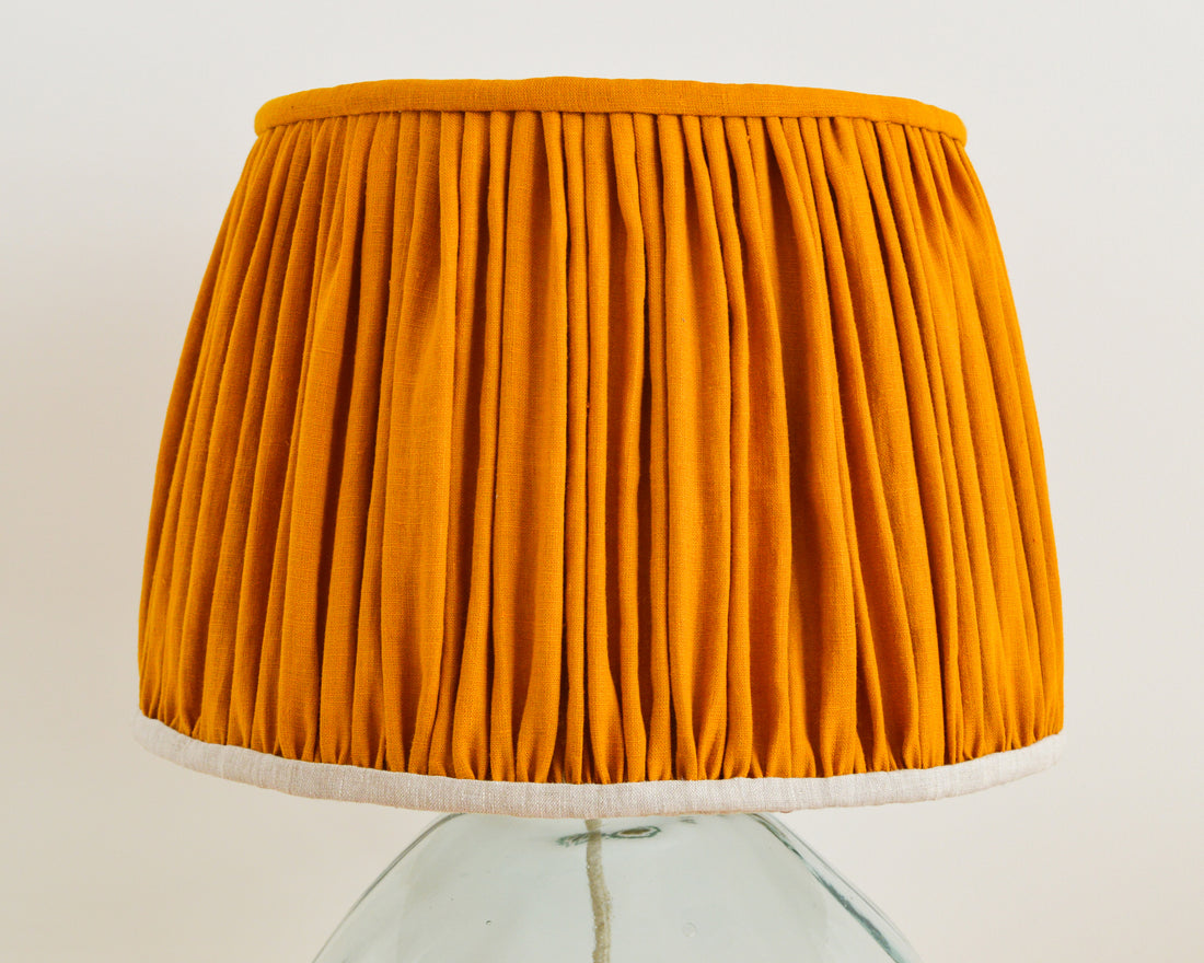 french drum mustard gathered lampshade on a glass lampbase